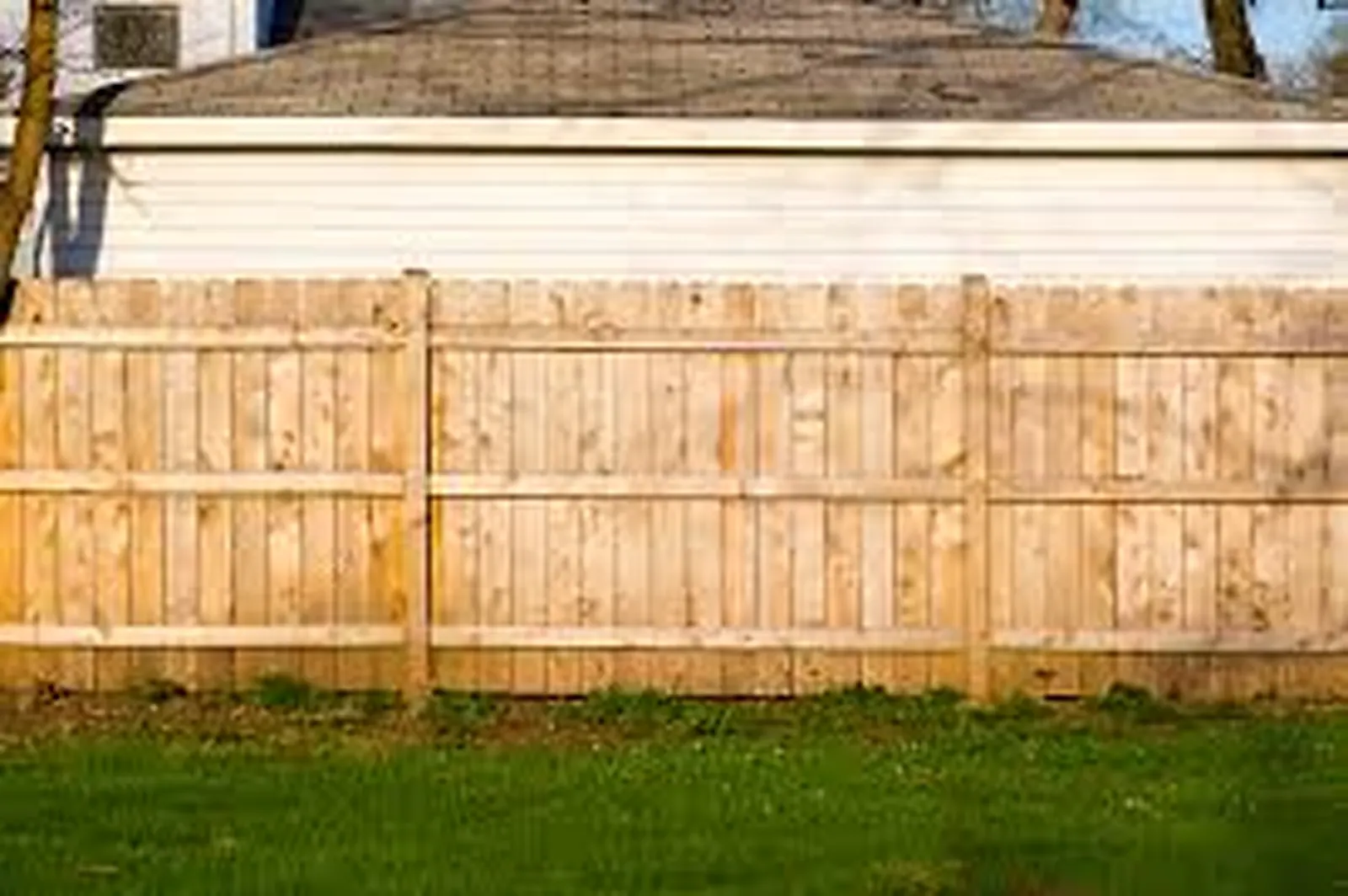 Wood privacy fence installation